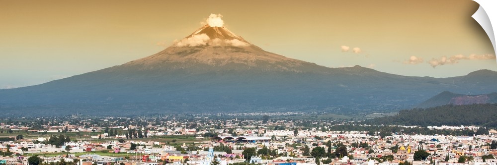 Panoramic aerial photograph of the Popocatepetl Volcano in Puebla, Mexico, with a bird's eye view of the city underneath. ...