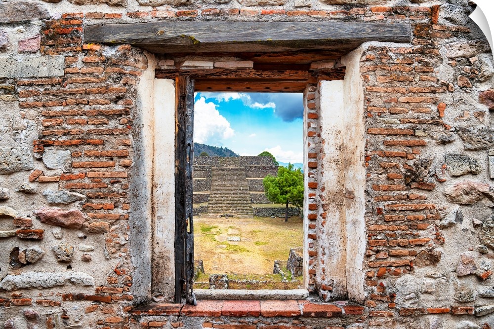 View of the Pyramid of Cantona, Mexico, framed through a stony, brick window. From the Viva Mexico Window View.