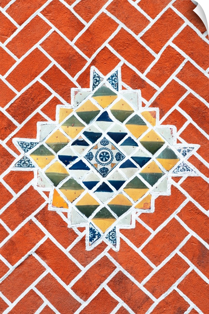 Decorative photograph of talavera tile creating a mosaic pattern surrounded by brick. From the Viva Mexico Collection.