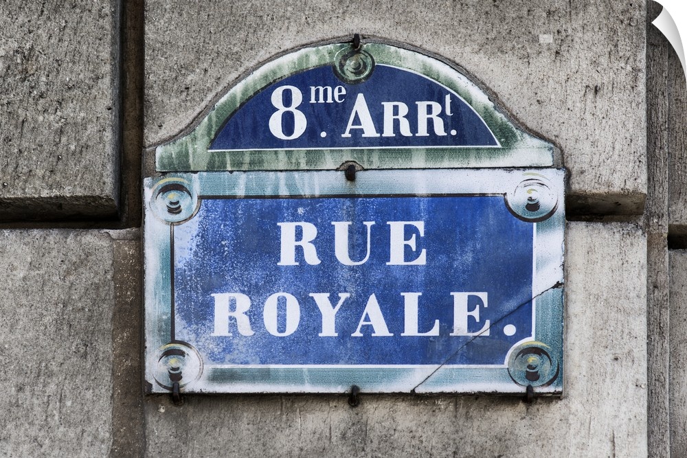 Photograph of a Parisian sign against a stone wall.