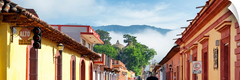 Panoramic photograph of a streetscape at San Cristobal de Las Casas in Chiapas, Mexico, with heavy fog in the background. ...