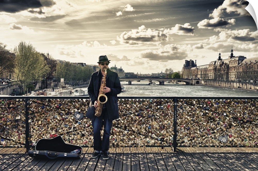 Fine art photo of a man playing the saxophone on bridge covered in locks in Paris, France.
