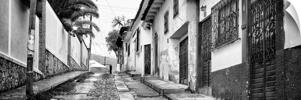 Black and white panoramic photograph of a streetscape at San Cristobal de Las Casas in Chiapas, Mexico. From the Viva Mexi...