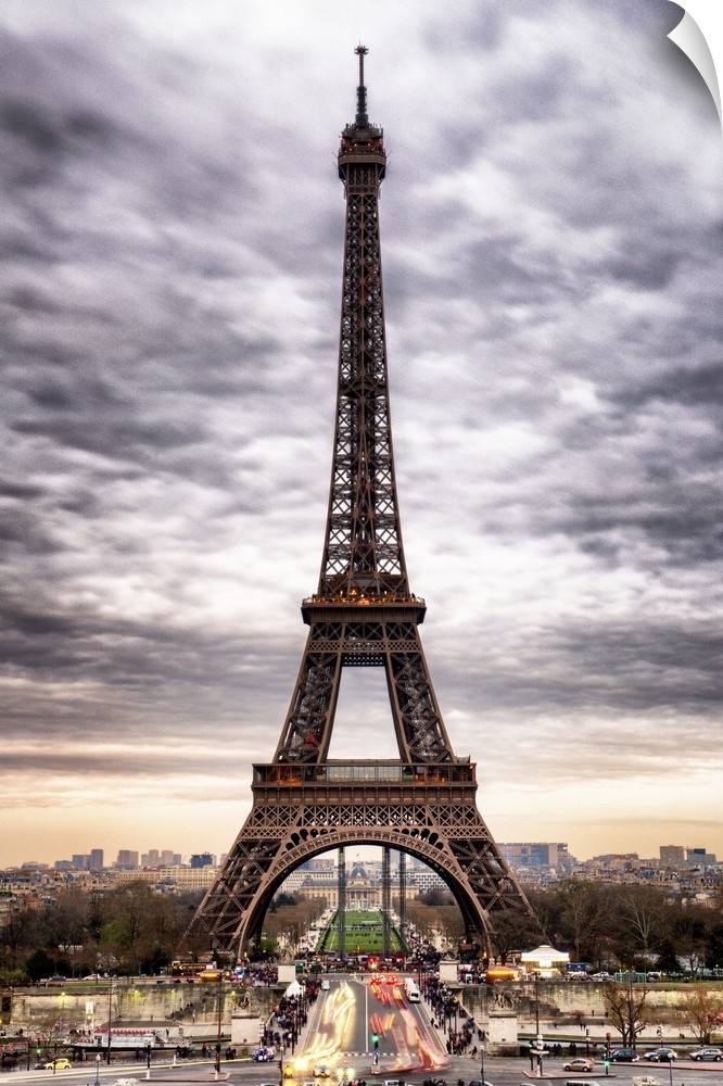 Stunning photograph of the iconic Eiffel Tower in Paris with cloudy skies.