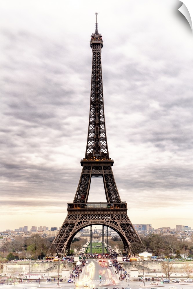 Stunning photograph of the iconic Eiffel Tower in Paris with cloudy skies.