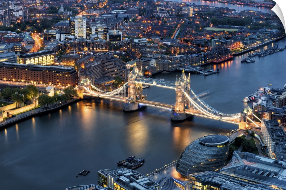 Fine art photo of the River Thames and the Tower Bridge lit up in the evening.