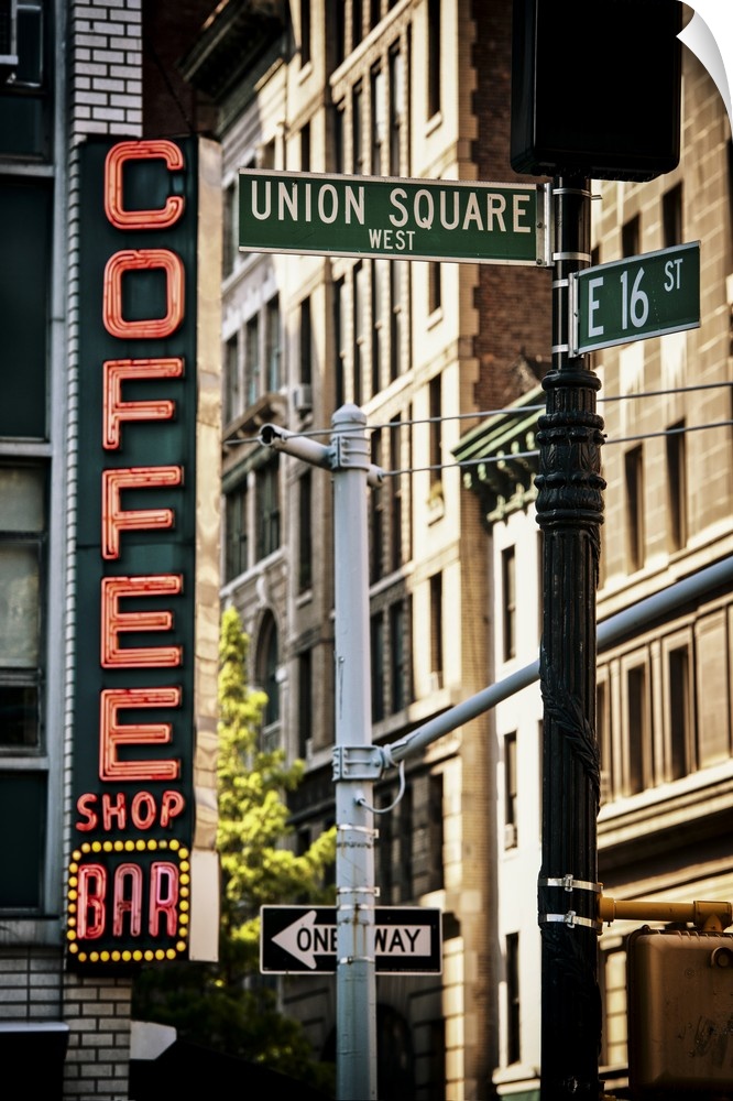 Street sign for Union Square, dwarfed by a gigantic neon coffee shop sign in the background.