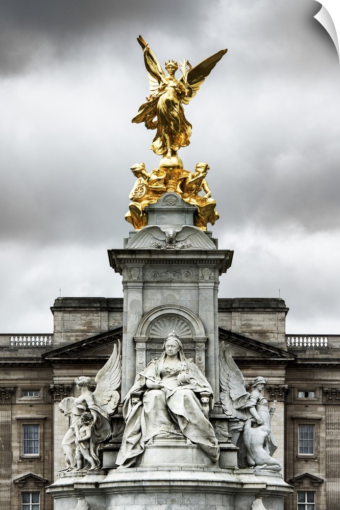 View of the golden statue at the top of the Victoria Memorial under a cloudy sky.