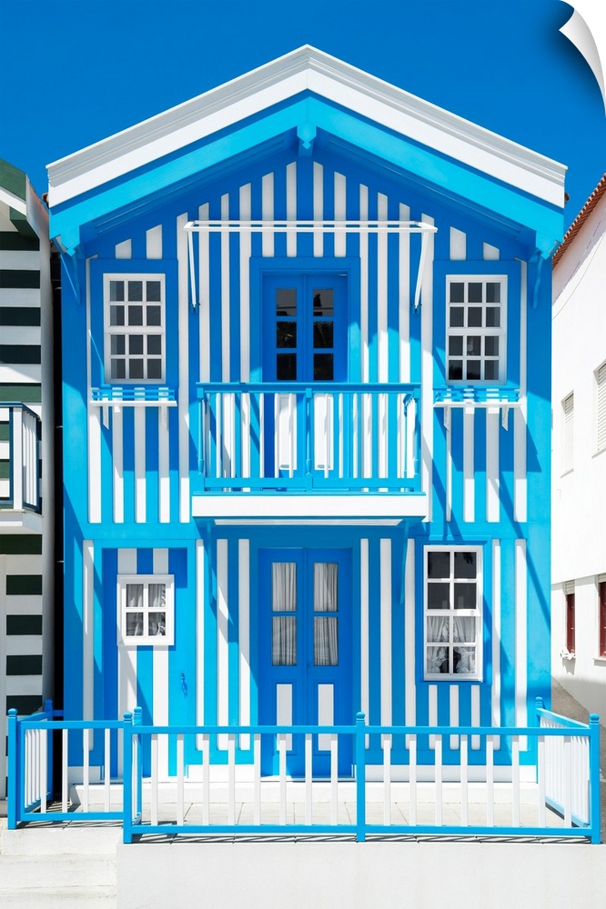Its' a typical house with blue stripes in Costa Nova Beach, Portugal.