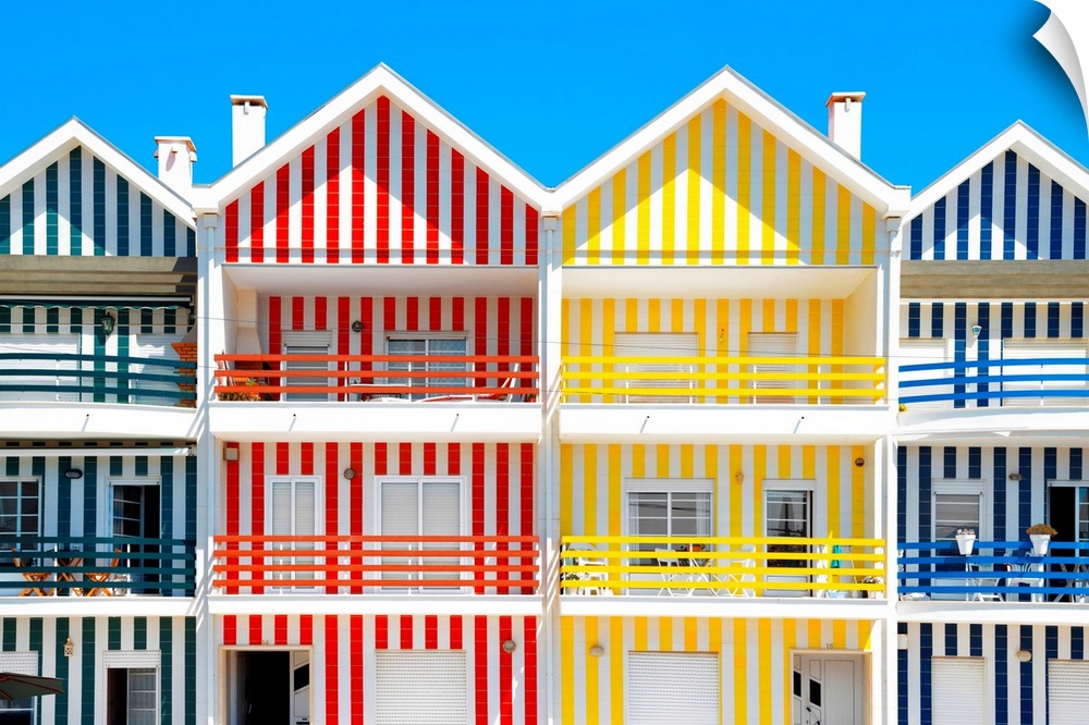 These are four facades of colorful houses with stripes in Costa Nova Beach, Portugal.