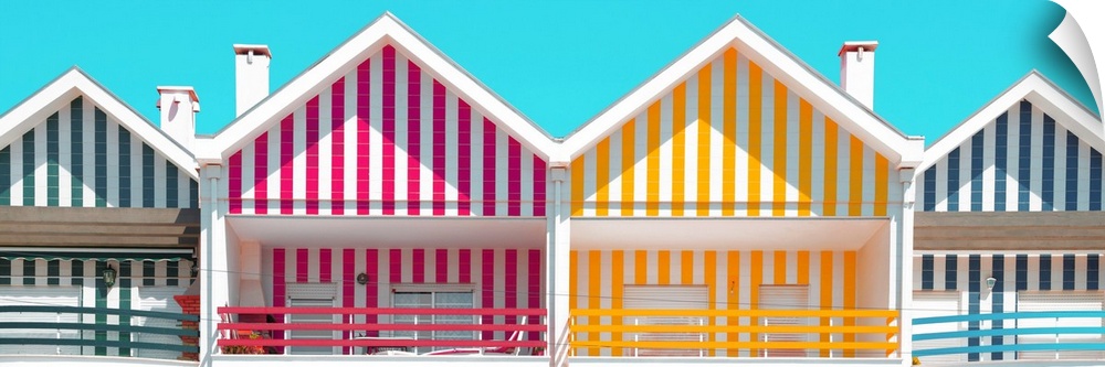 These are four facades of colorful houses with stripes in Costa Nova Beach, Portugal.