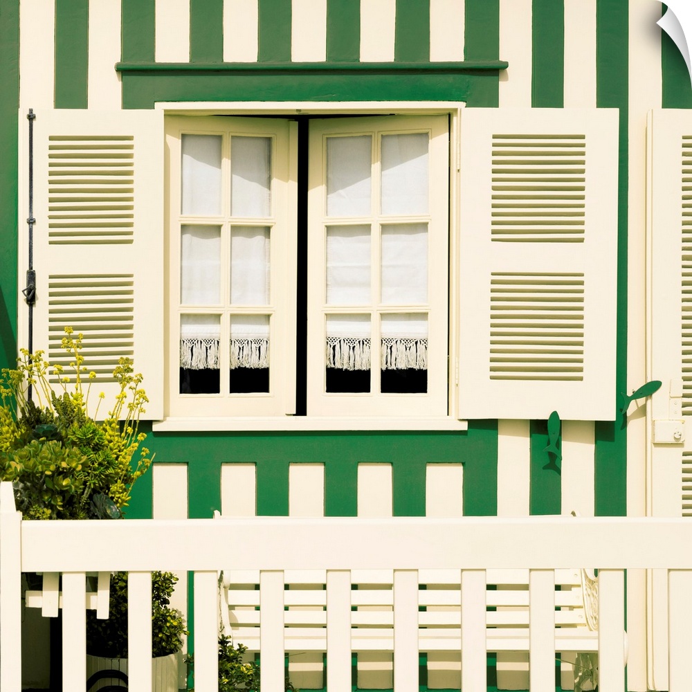 Its' a traditional window with green stripes at Costa Nova Beach in Portugal.