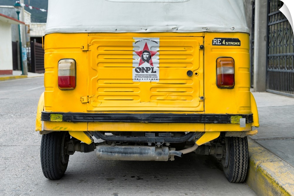 Close-up photograph of the rear side of a yellow tuk tuck (taxi) in Mexico. From the Viva Mexico Collection.