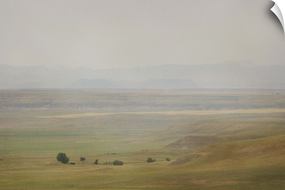 A pictorialist landscape photograph of a western prairie landscape of Montana, USA. Farms up against the buttes form a sce...