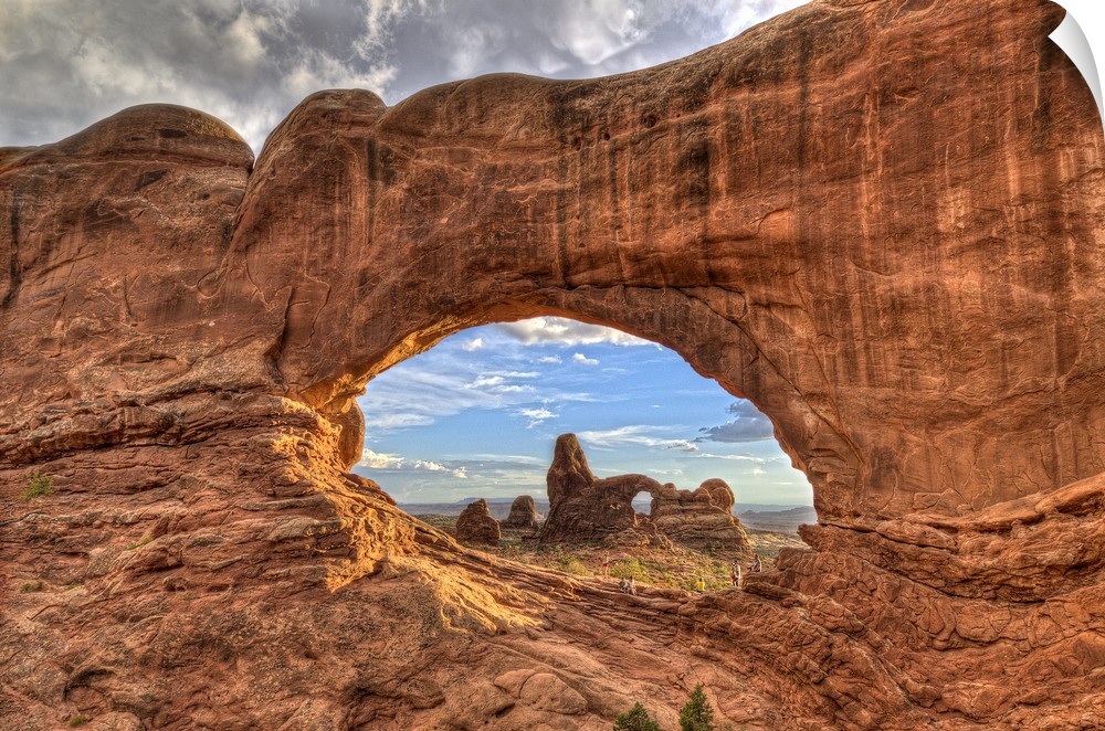 Photograph of a large rock formation seen through a rock arch.