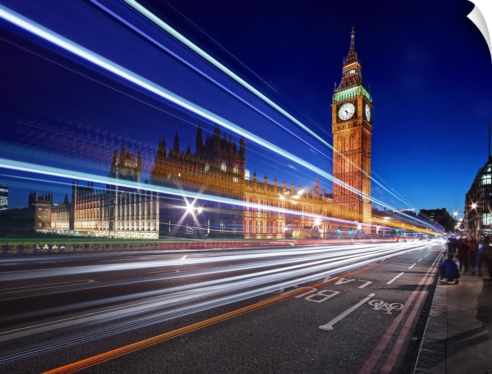Light trails from passing cars in front of Big Ben and Parliament in London, England, in the evening.