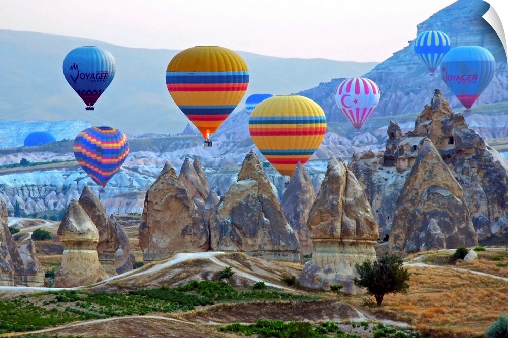 Colorful hot air balloons over the rocky landscape of Cappadocia, Turkey.