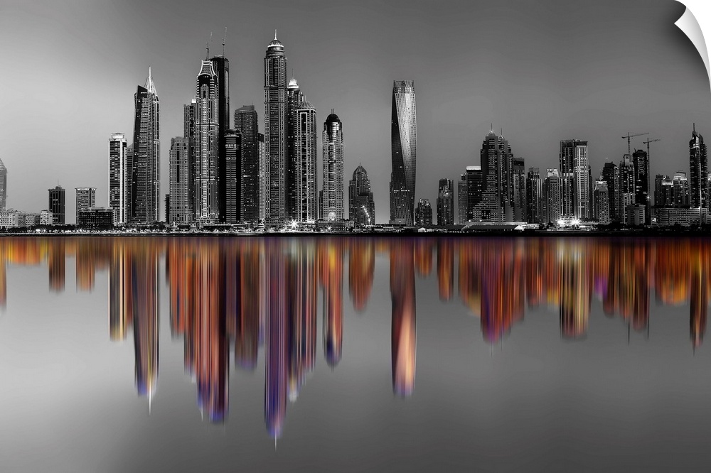 Black and white image of hte Marina Towers in Dubai, with a reflection in color.