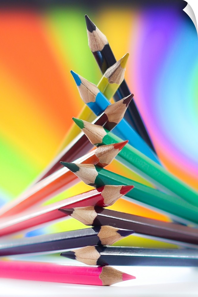 Colored pencils arranged in a pile, with rainbow colors.