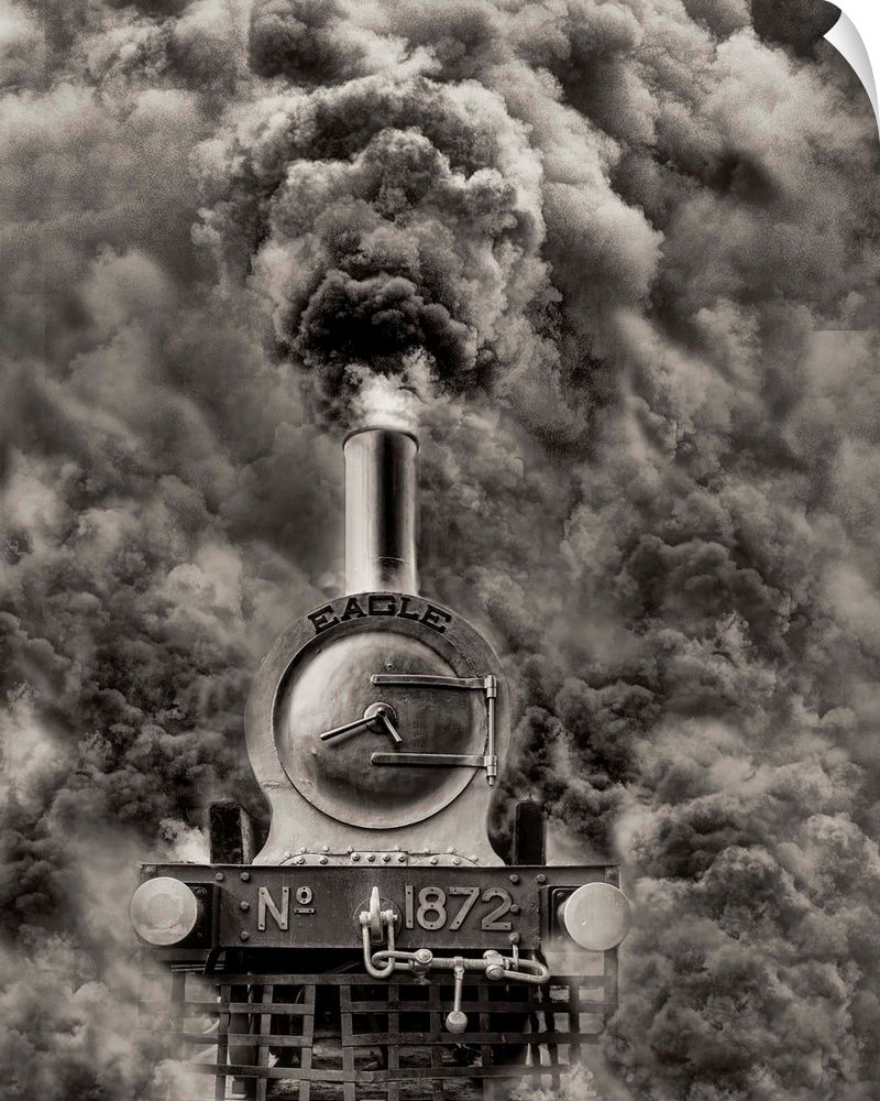 Locomotive with black smoke billowing out of its smokestack.
