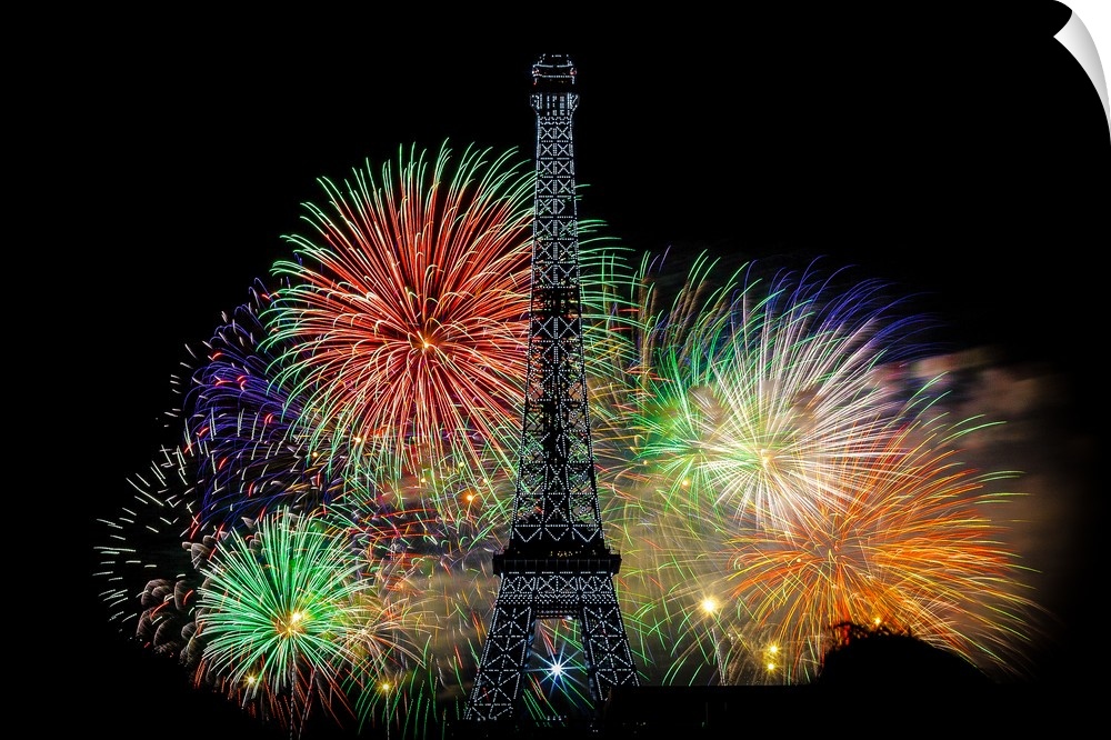 Fireworks exploding in the air behind the Eiffel Tower in Paris.