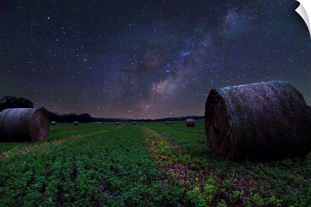 Hay field in Nebraska under the beautiful night sky, with the Milky Way visible.