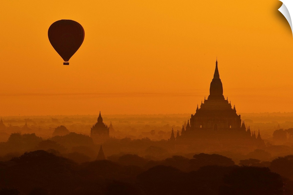 Silhouette of a balloon over temples in the morning in Bagan, Myanmar