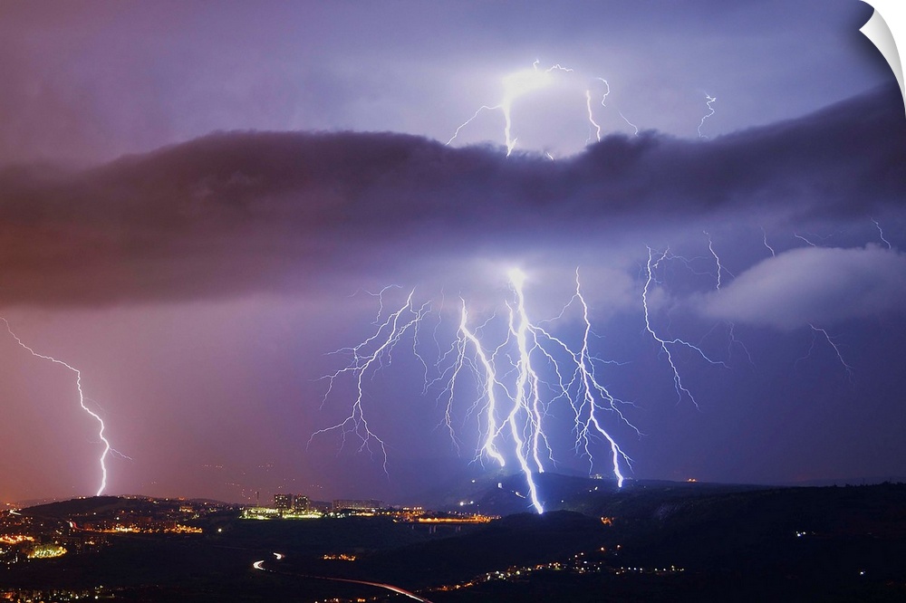 This is a single exposure image of several consecutive lightning strikes into hills above Trieste, Italy.