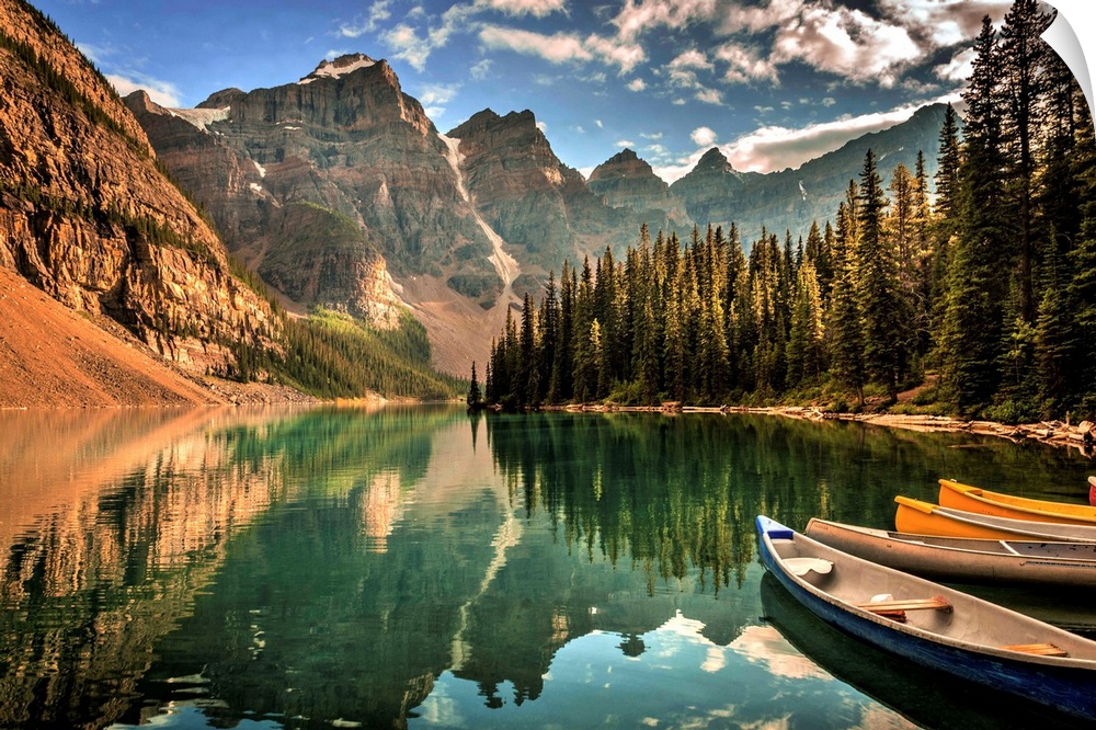 Photograph of a still lake with canoes in the Canadian Rockies, Banff National Park.