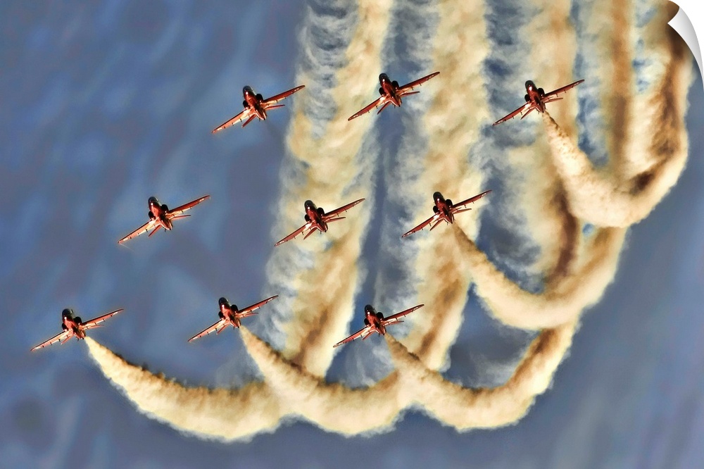 Nine jets flying in formation leaving trails in the sky.