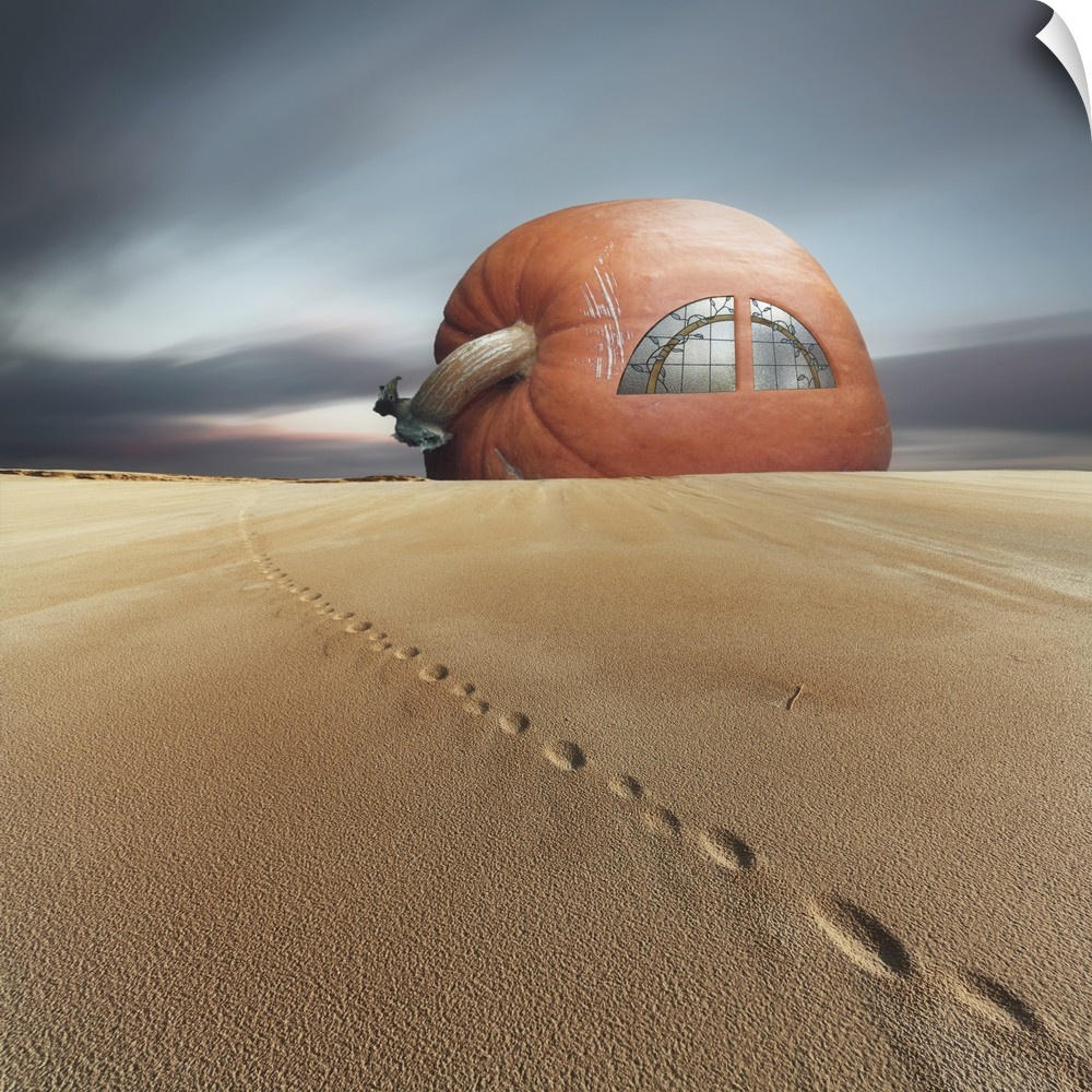 Conceptual photo of a house made of a giant pumpkin in the sand.