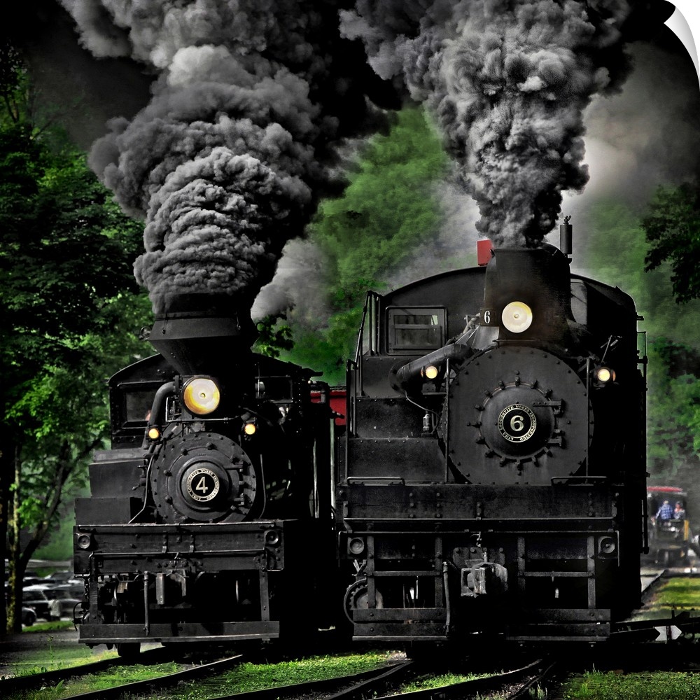 Two black locomotives approaching on the railroad tracks.