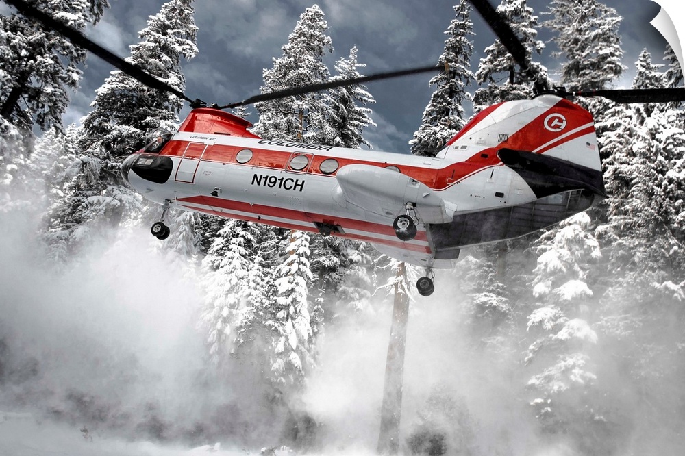 A helicopter lifts up off the ground, sending snow flying away.