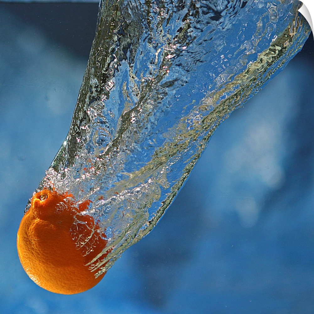 A tangerine dropped in water.