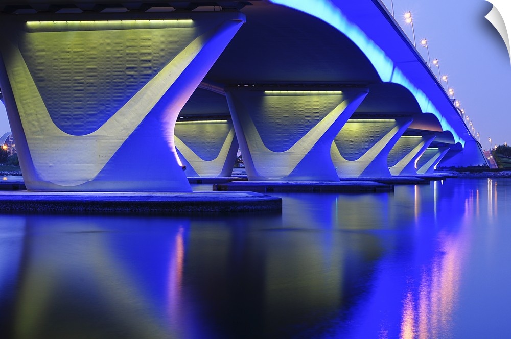 Photograph of a bridge lit up in blue neon lights.