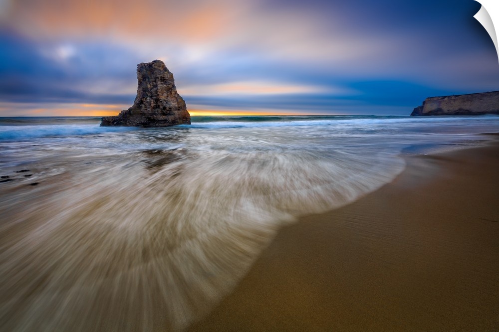 Sea stack in the ocean on the Santa Cruz beach, California, at sunset.