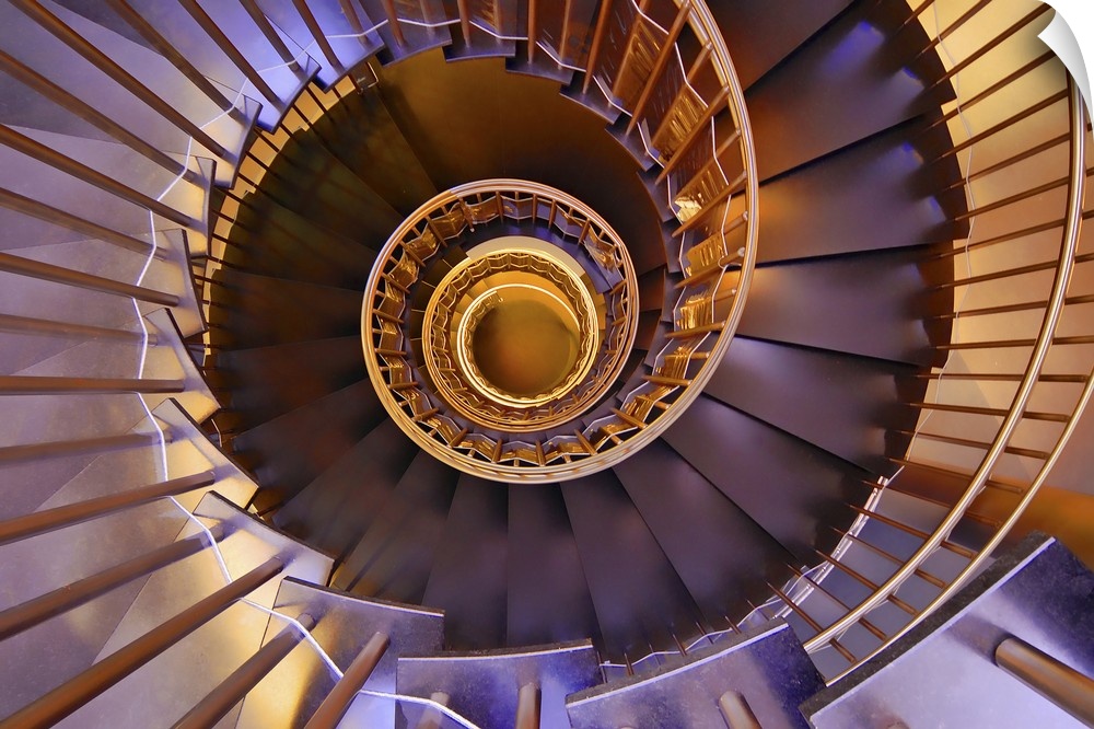 Looking down a spiral staircase with glowing yellow and purple lights.