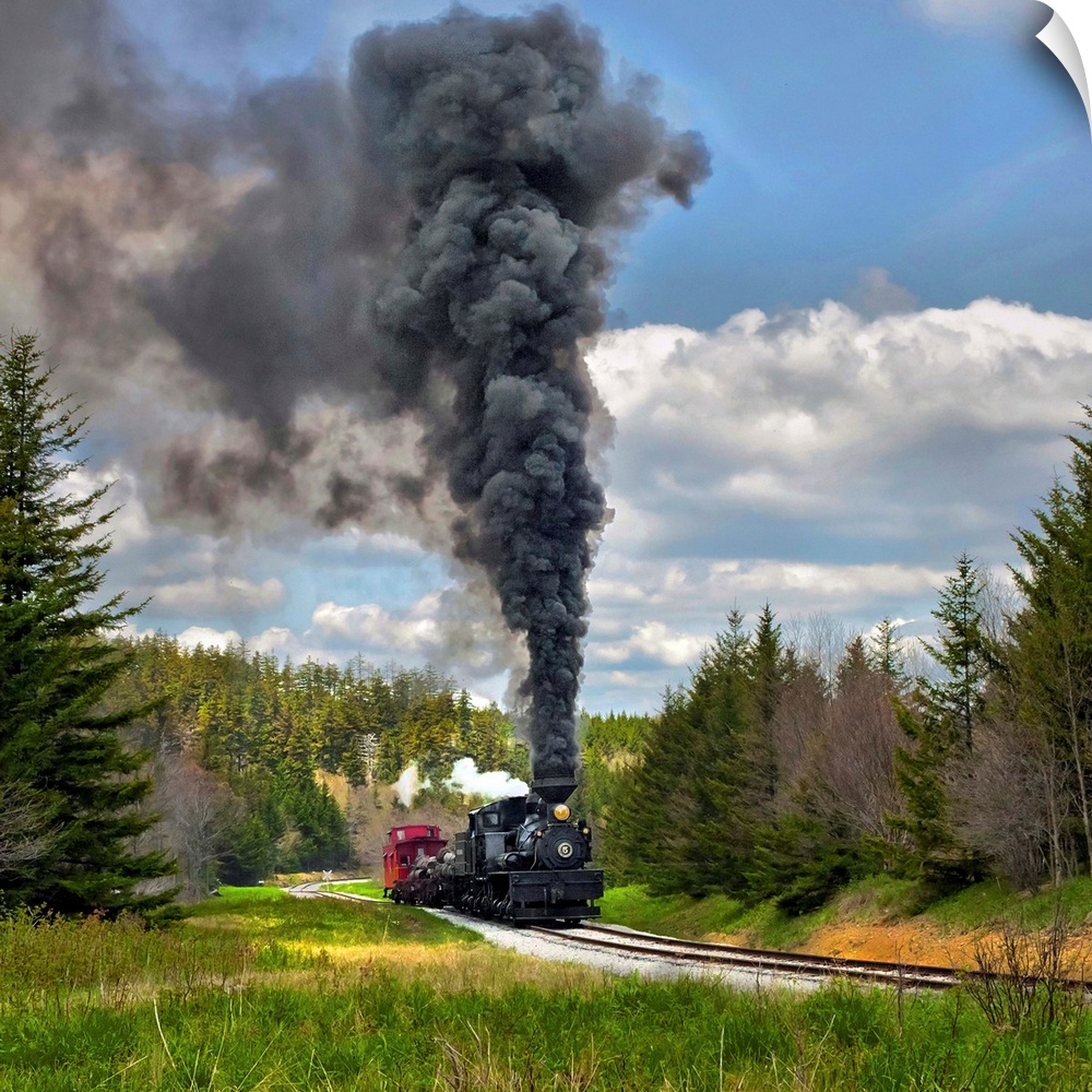 Locomotive with dark smoke billowing from its smokestack.