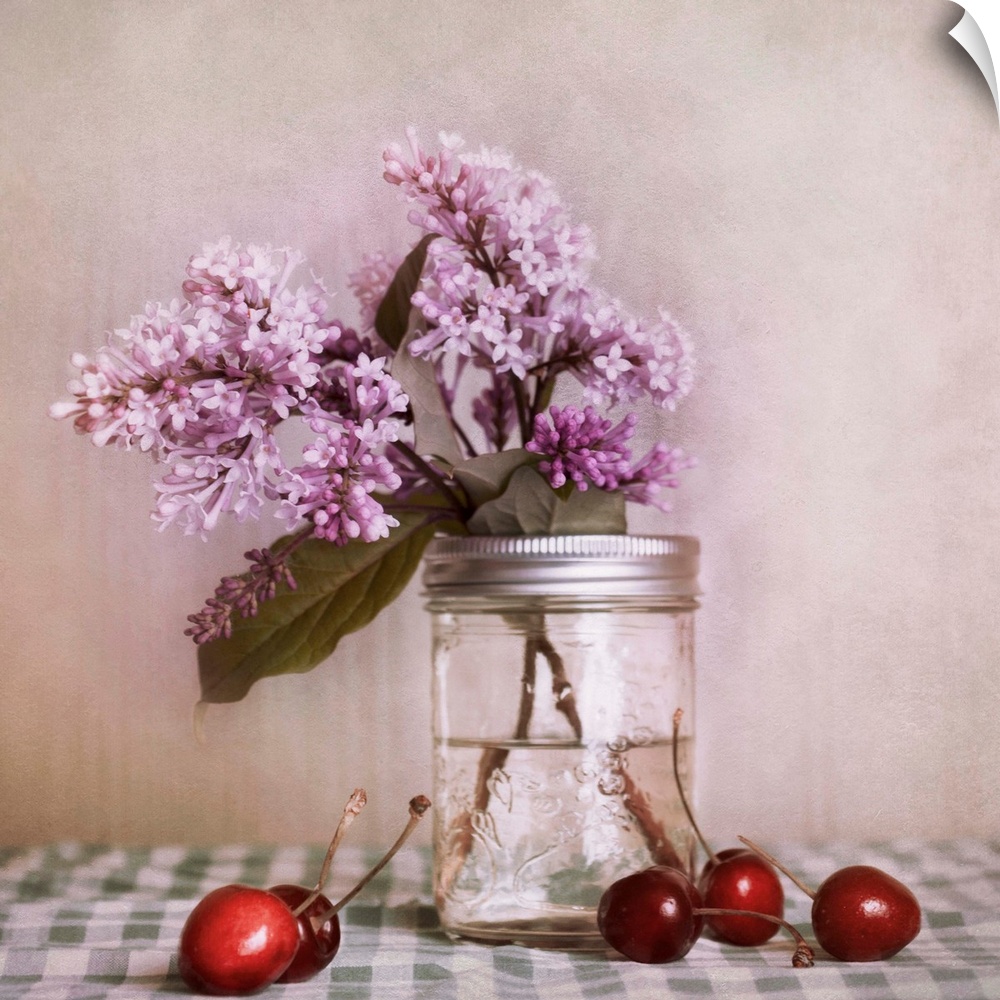 A still life, with lilac blossoms and red cherries