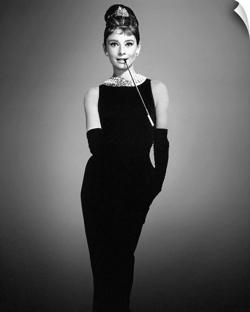 Audrey Hepburn in her classic "Breakfast at Tiffany's" outfit on a soft background.