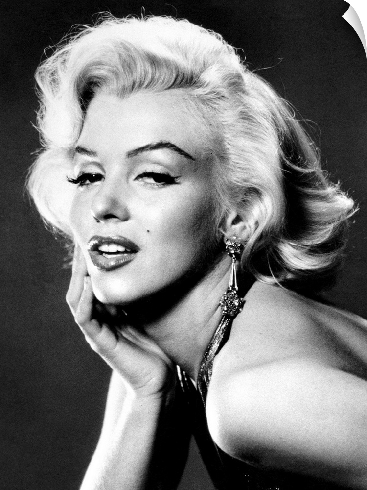 Large, portrait, black and white photograph of Marilyn Monroe, leaning forward with her palm on her face.