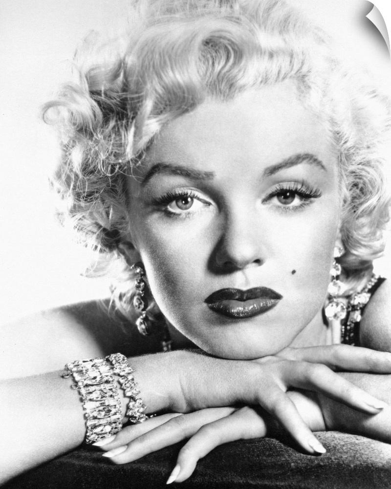 This is a monochromatic portrait photograph from the shoulders up of the Hollywood Icon wearing makeup and diamonds with h...
