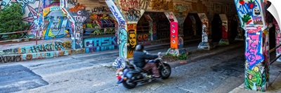 A motorcyclist enters the graffiti-covered Krog Street Tunnel in Atlanta, Georgia