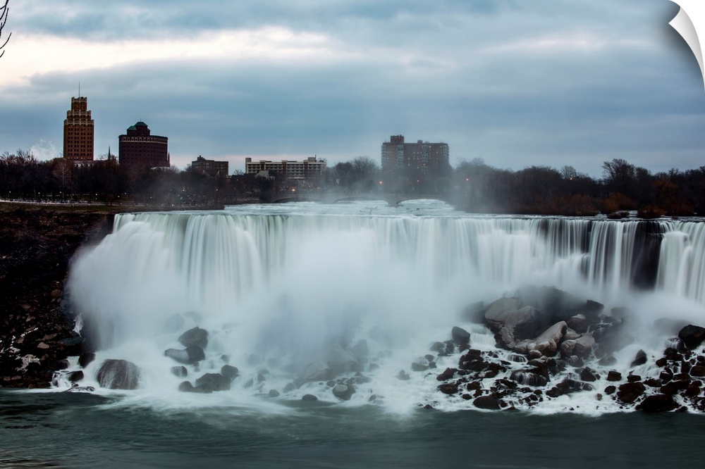 View of America Falls at Niagara Falls with United States Visitor Center in the background.
