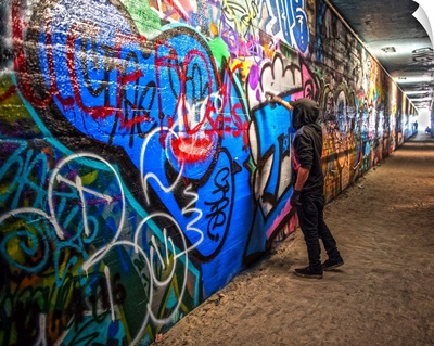 An artist paints the walls of the Krog Street Tunnel in Atlanta, Georgia