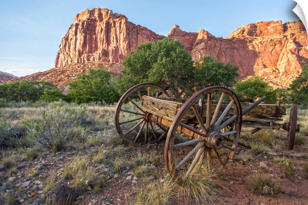 An antique wagon under Fruita's rock formations in Capitol Reef National Park, Utah.