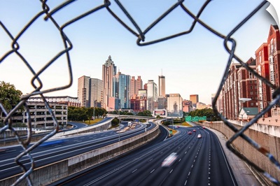 Atlanta, Georgia skyline framed by a chain link fence