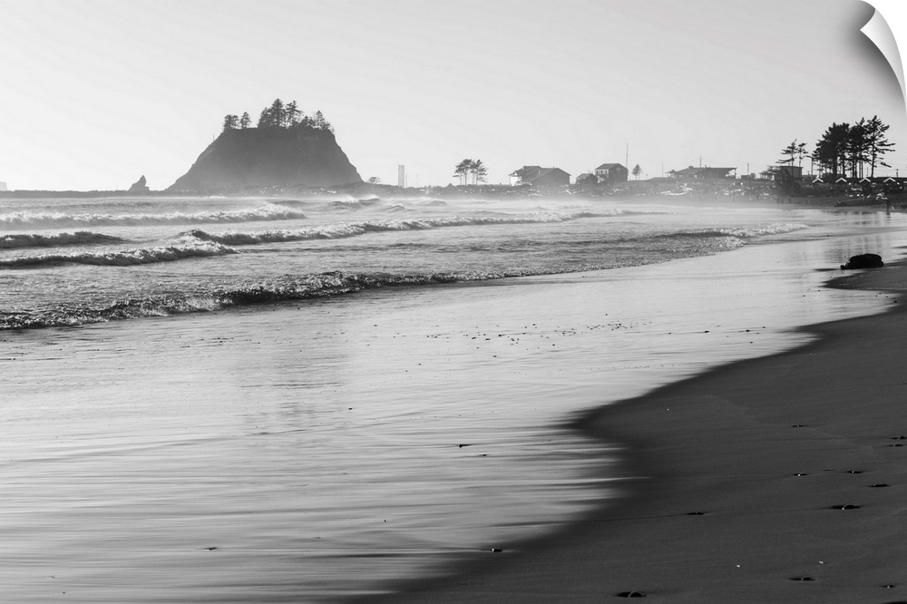 Black and white landscape photograph of the La Push Beach shore with misty rock cliffs in the background.