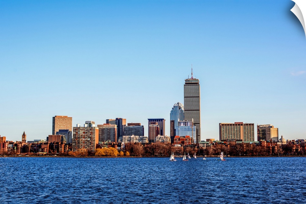 View of Boston city skyline and Prudential Tower with sailboats on the Charles River.
