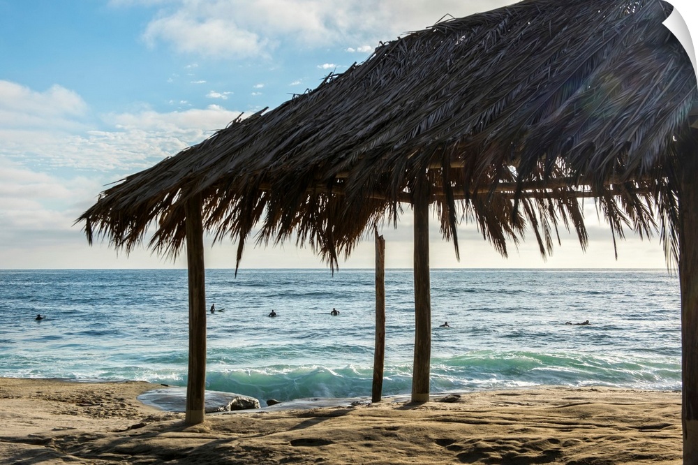 Photograph of a cabana made with natural materials on the shore of Windansea Beach, San Diego on a beautiful day.